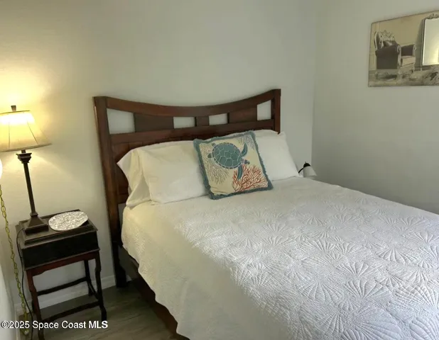 a bedroom with a bed and a night stand