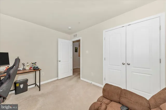a view of a livingroom with workspace and a couch