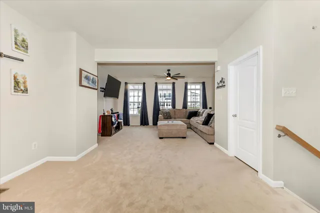 a living room with furniture and a large mirror