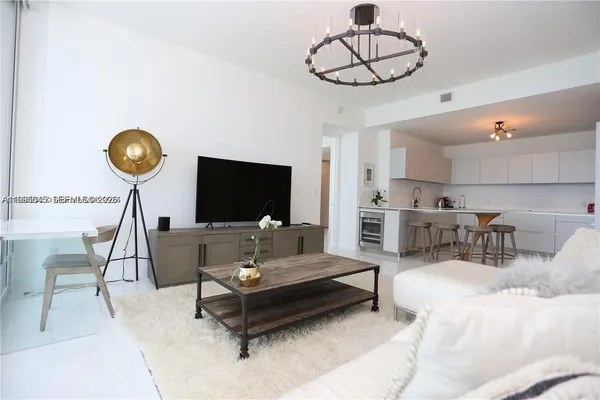 a kitchen with granite countertop a white cabinets and chairs