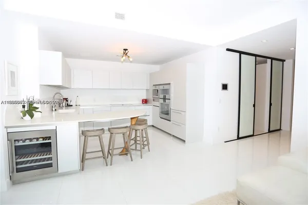 a view of a hallway with a glass door and bathroom