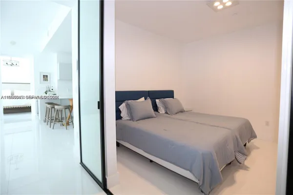 a spacious bathroom with double sink and a mirror