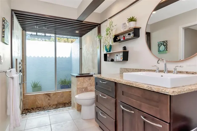 a living room with furniture and view of kitchen