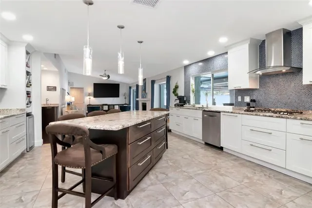 a living room with lots of furniture and a large window