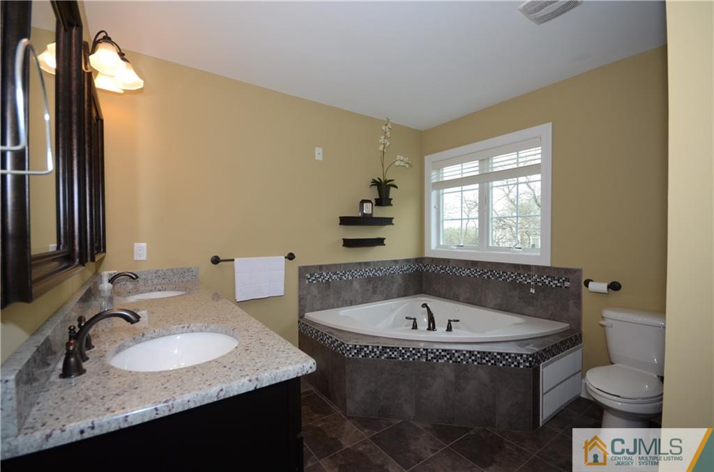 88 Dublin Road Skillman, NJ 08558 - Photo 12 of 22 a bathroom with a granite countertop sink and a bathtub