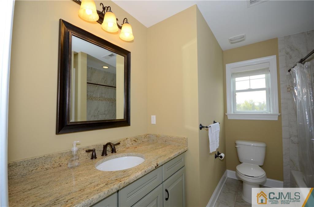 88 Dublin Road Skillman, NJ 08558 - Photo 18 of 22 a bathroom with a granite countertop sink toilet and mirror