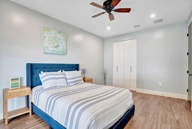 2622 Northeast 27th Avenue Lighthouse Point, FL 33064 - Photo 18 of 24 a bedroom with a large bed and a chandelier