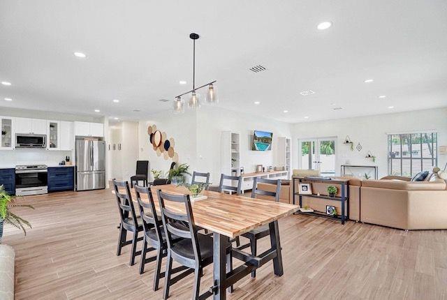 2622 Northeast 27th Avenue Lighthouse Point, FL 33064 - Photo 10 of 24 a view of a dining room and livingroom with furniture wooden floor a chandelier