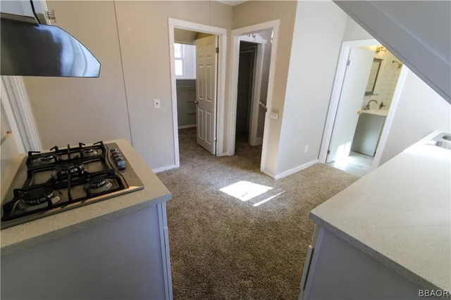 a kitchen with sink stove and refrigerator