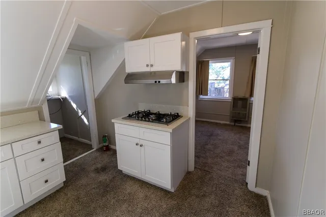 a kitchen with cabinets and window