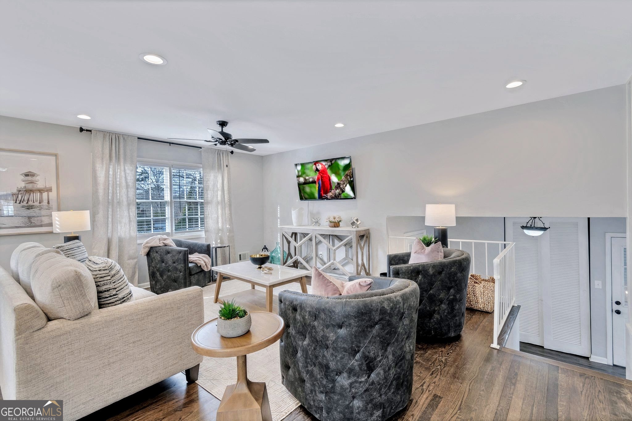 a living room with furniture potted plant and a window