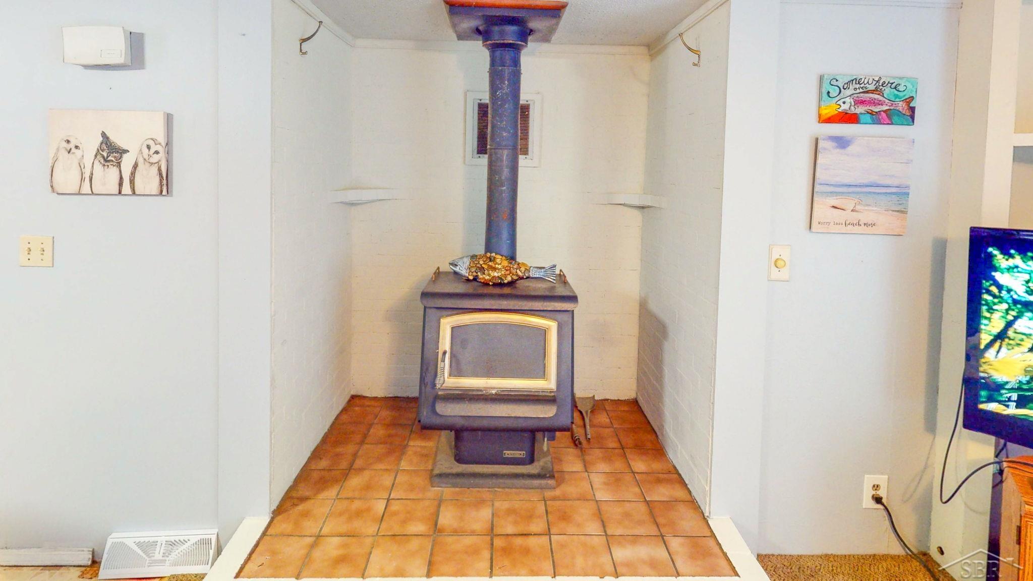670 Lone Pine Road Harrison, MI 48625 - Photo 17 of 34 Cozy up by the wood stove after a day of hiking, skiing, or ice fishing nearby.