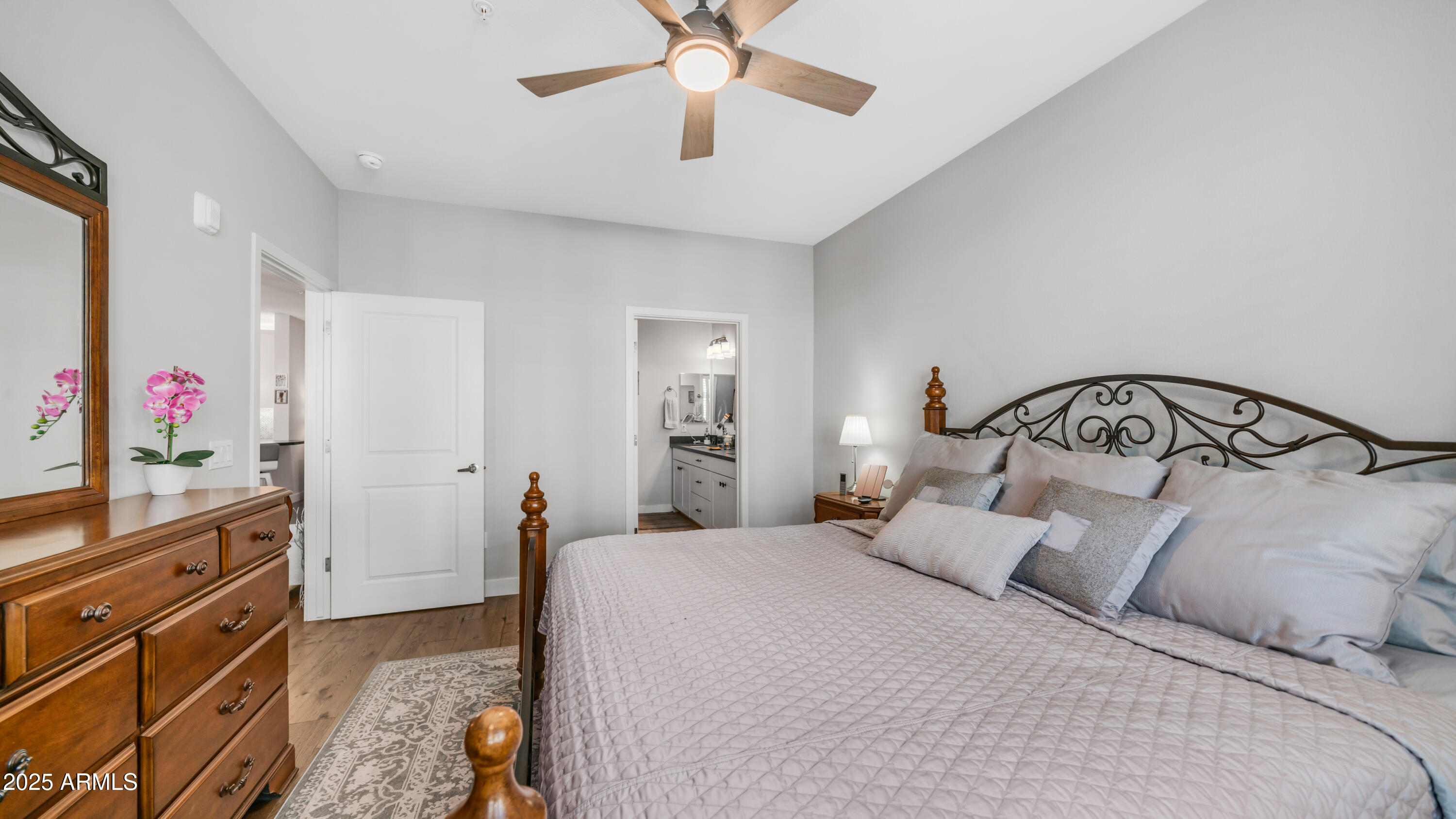 2511 West Queen Creek Road, Unit 166 Chandler, AZ 85248 - Photo 19 of 66 a bedroom with a bed and a chandelier