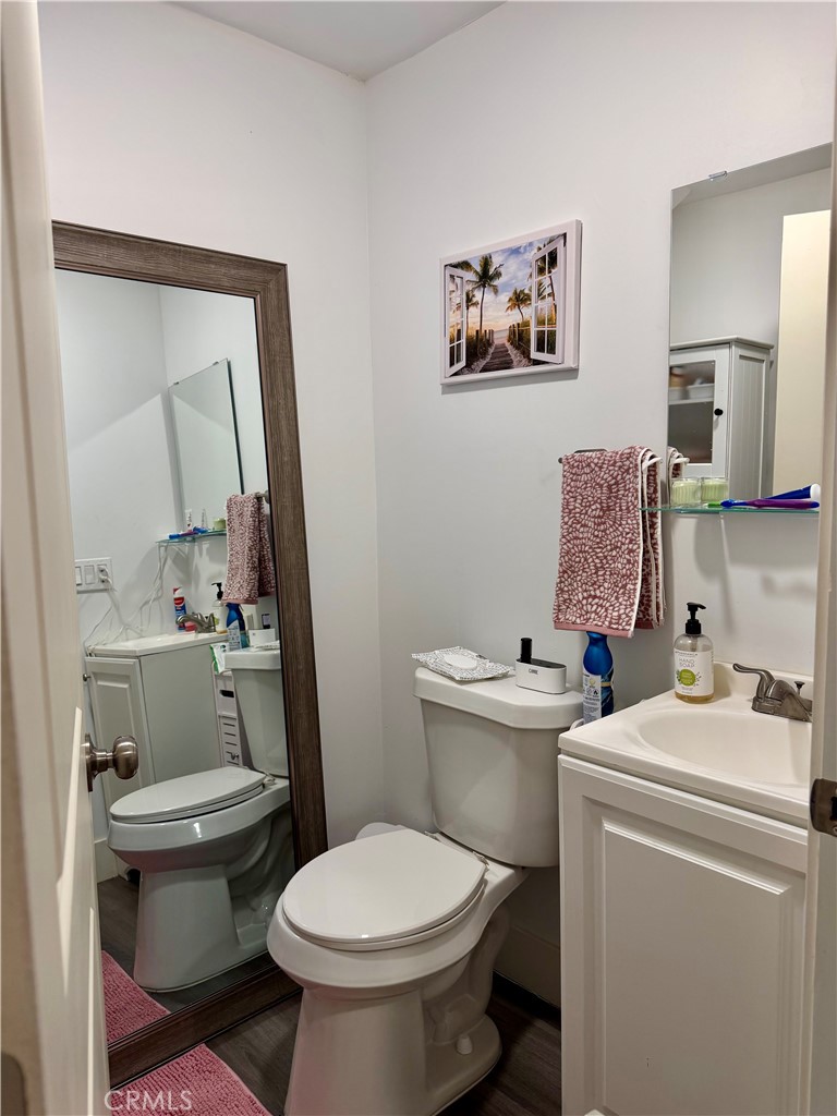 206 East Raymond Street Compton, CA 90220 - Photo 12 of 12 a bathroom with a toilet a sink and a mirror