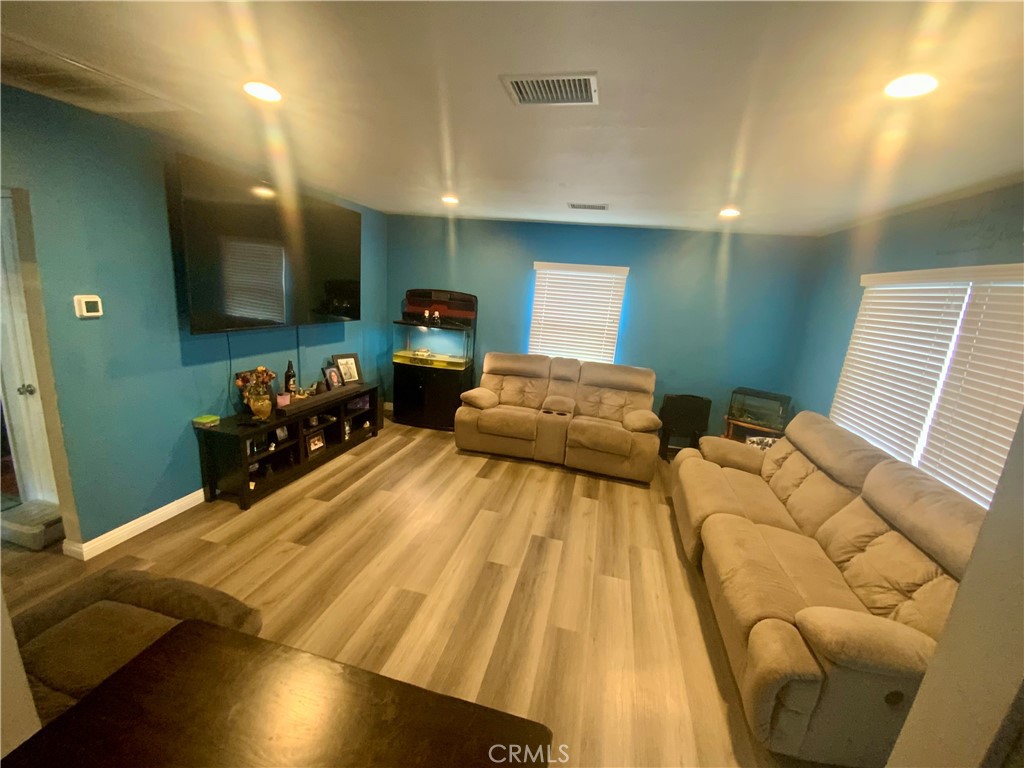 206 East Raymond Street Compton, CA 90220 - Photo 4 of 12 a bedroom with a bed a mirror on desk and chair