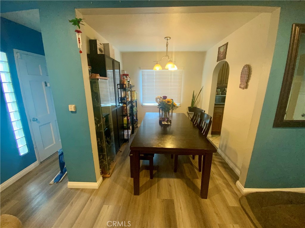 206 East Raymond Street Compton, CA 90220 - Photo 5 of 12 a view of a dining room with furniture and wooden floor