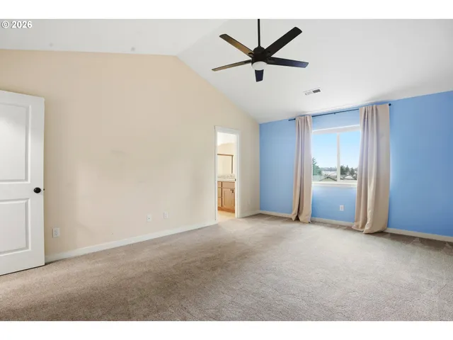 a view of a livingroom with a ceiling fan and window