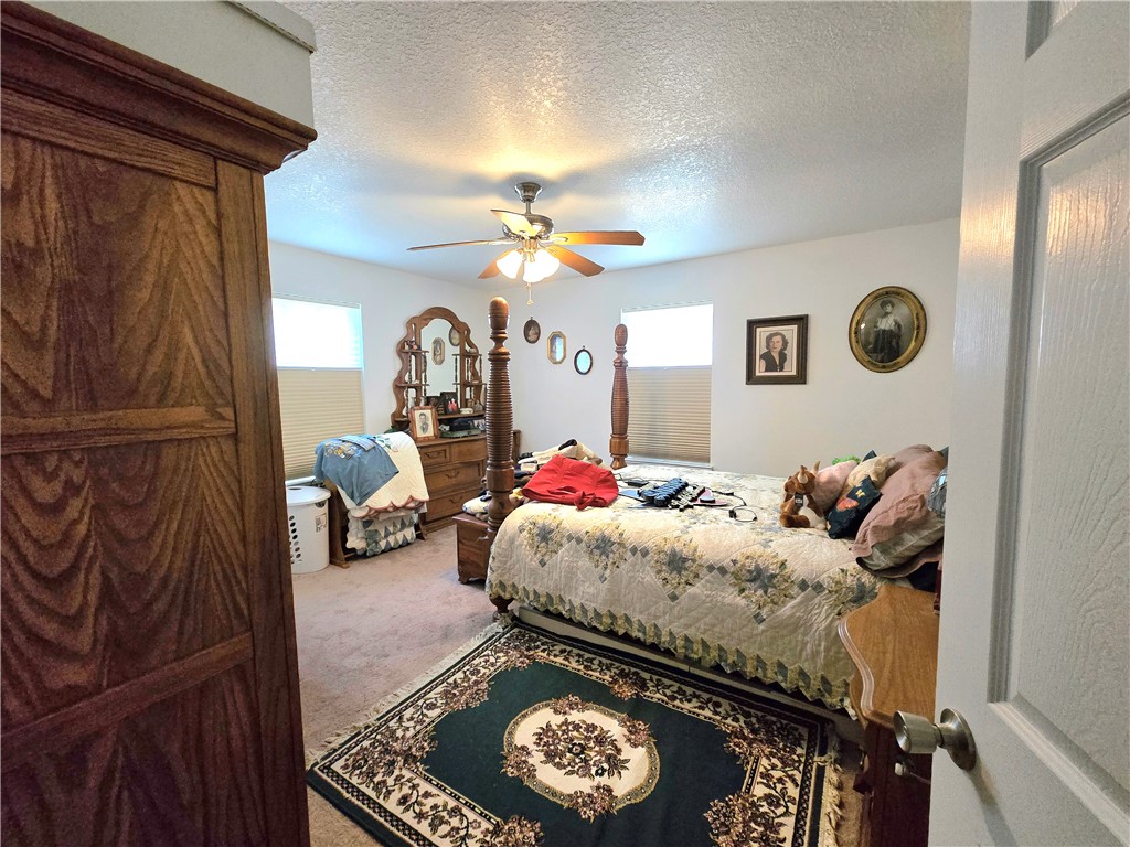 402 Shadow Arbor Circle Somerville, TX 77879 - Photo 15 of 26 a bed room with a bed and a chandelier