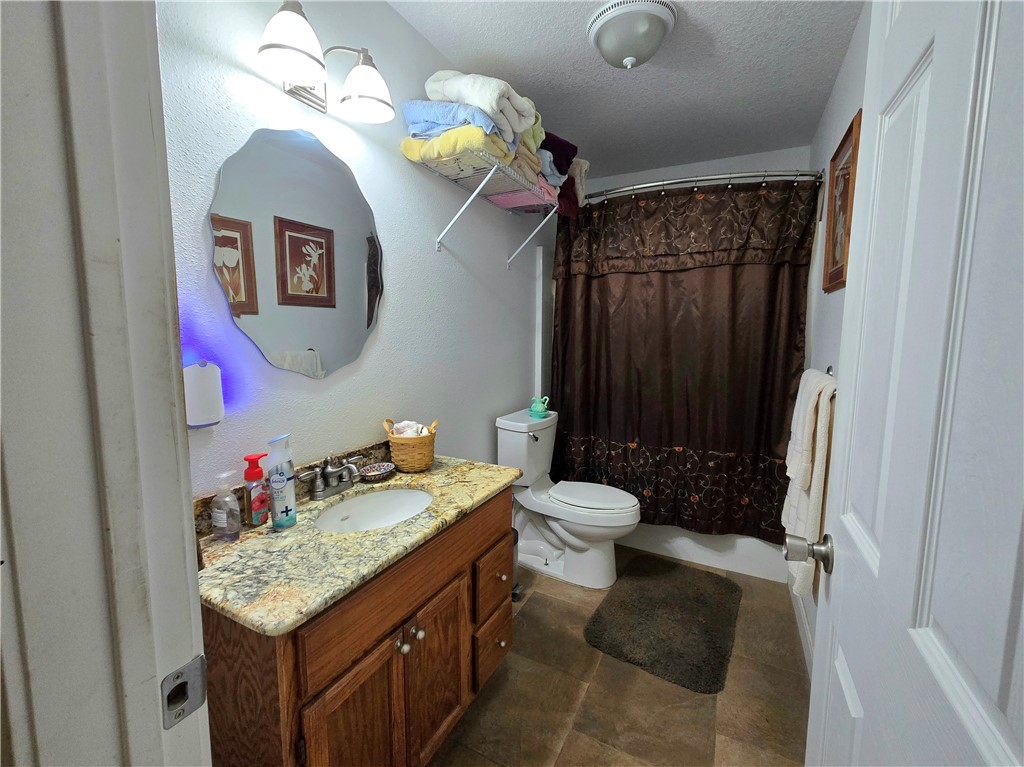 402 Shadow Arbor Circle Somerville, TX 77879 - Photo 16 of 26 a bathroom with a granite countertop sink and a mirror