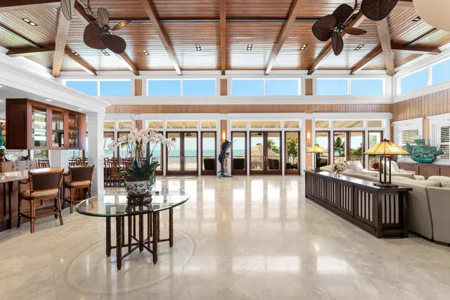 a living room with furniture a flat screen tv and a large window