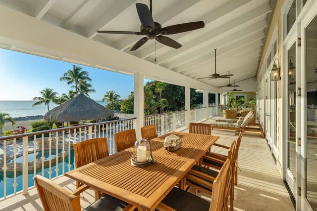 a living room with furniture floor to ceiling window and wooden floor