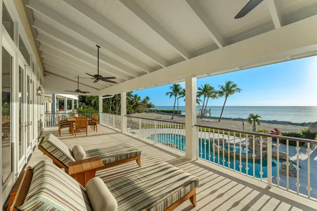 a view of a house with sitting area and swimming pool