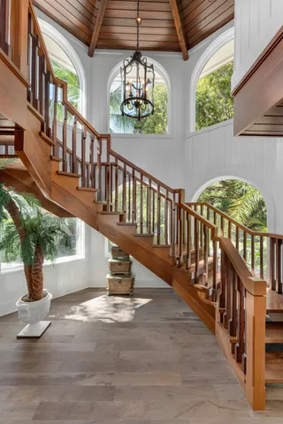 an aerial view of a house with swimming pool and outdoor seating