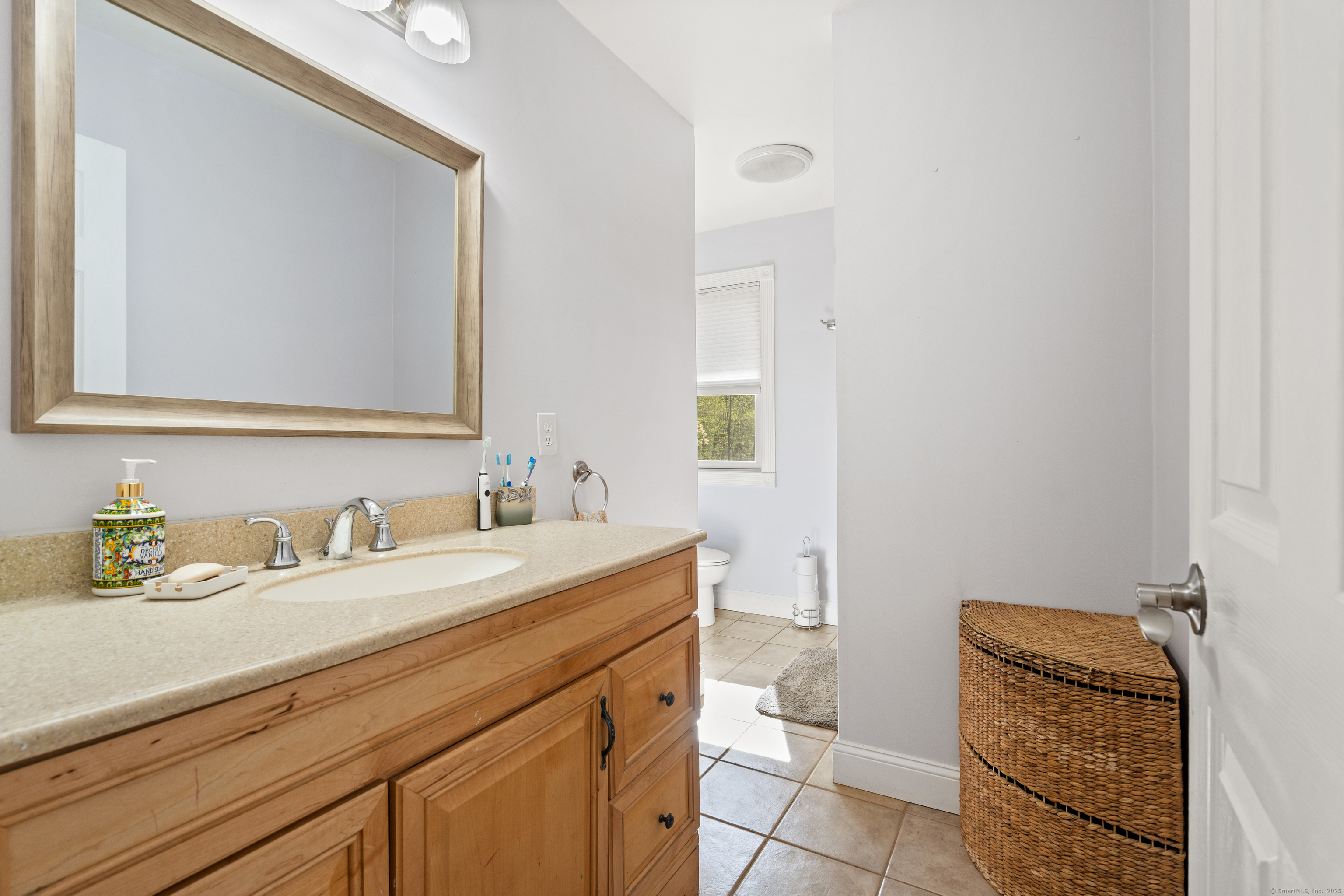 2 Pine Hill Road New Fairfield, CT 06812 - Photo 16 of 40 a bathroom with a granite countertop sink a toilet and a mirror