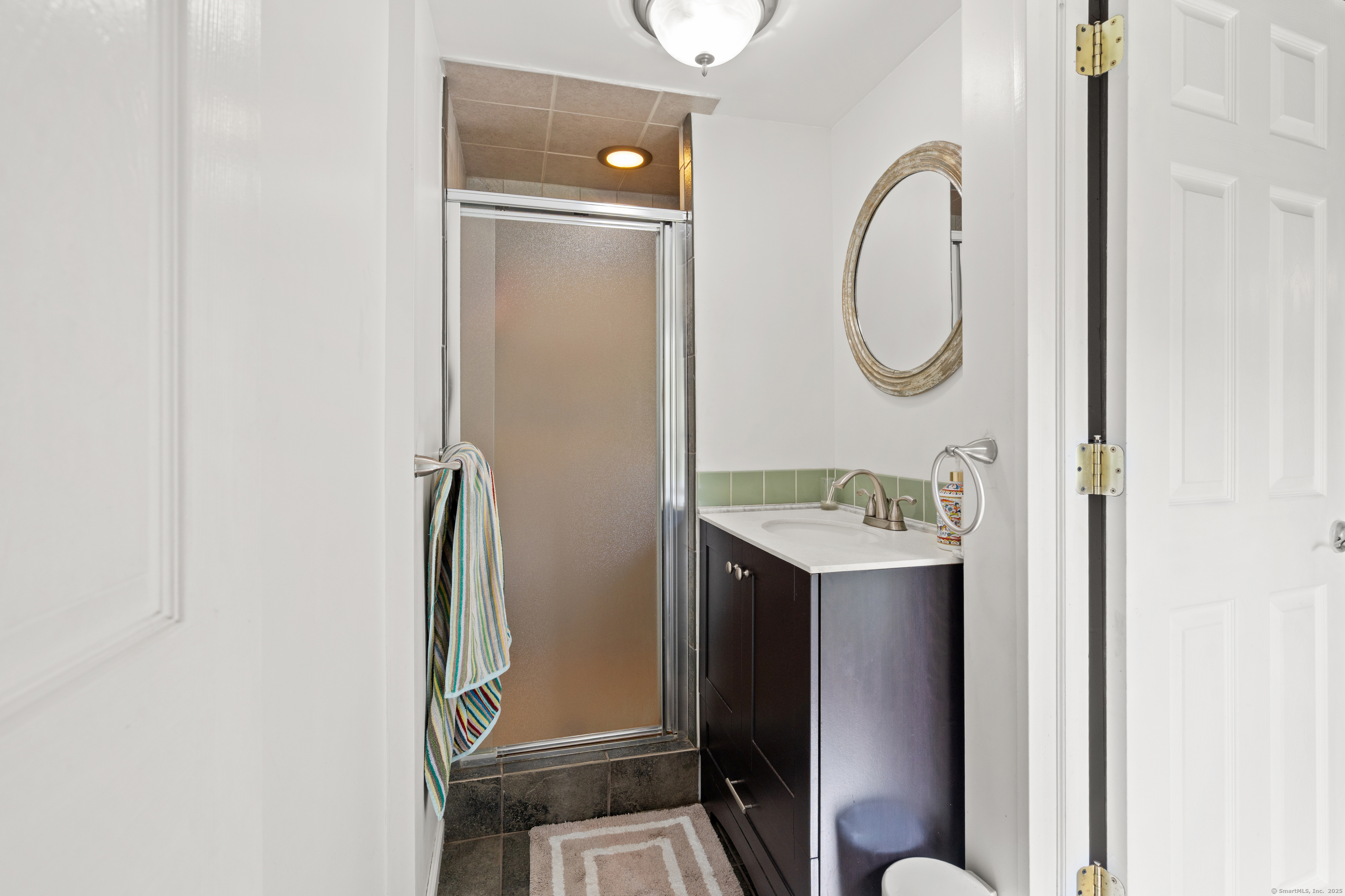 2 Pine Hill Road New Fairfield, CT 06812 - Photo 21 of 40 a bathroom with a sink mirror toilet and shower