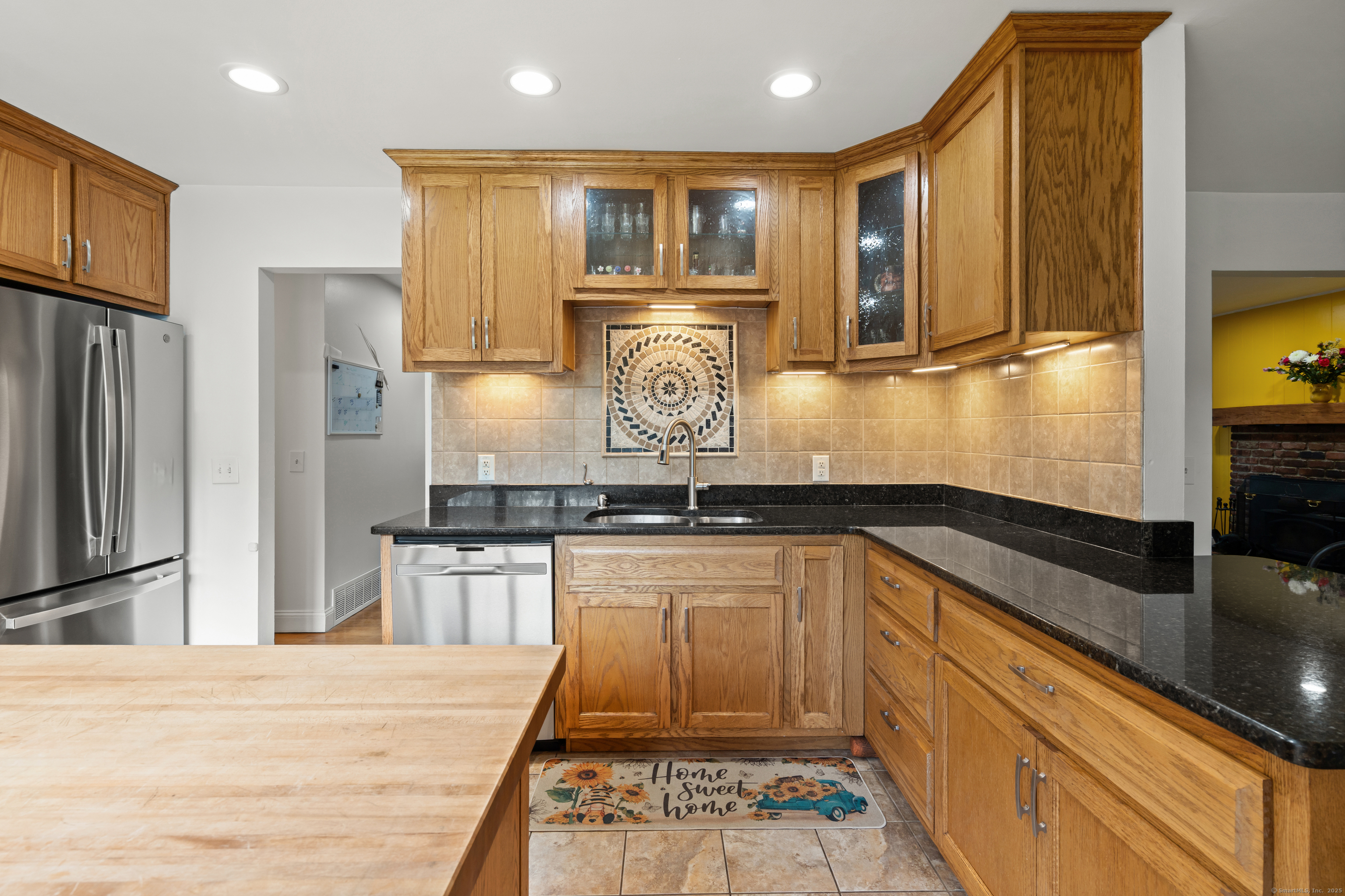 2 Pine Hill Road New Fairfield, CT 06812 - Photo 9 of 40 a kitchen with stainless steel appliances granite countertop a refrigerator a stove and a sink with wooden floor