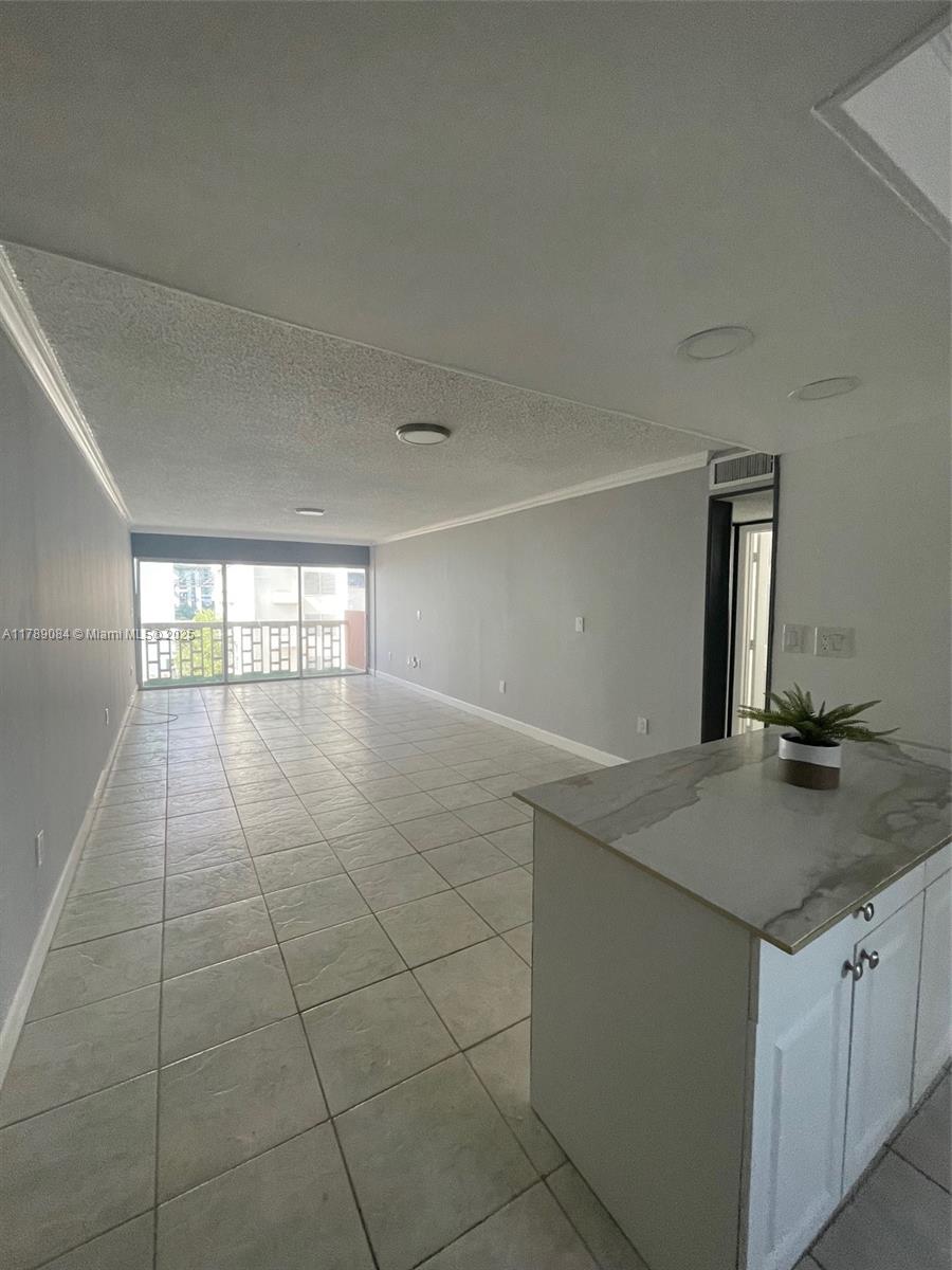 600 Northeast 25th Street, Unit 60 Miami, FL 33137 - Photo 4 of 10 a kitchen with a sink cabinets and a window