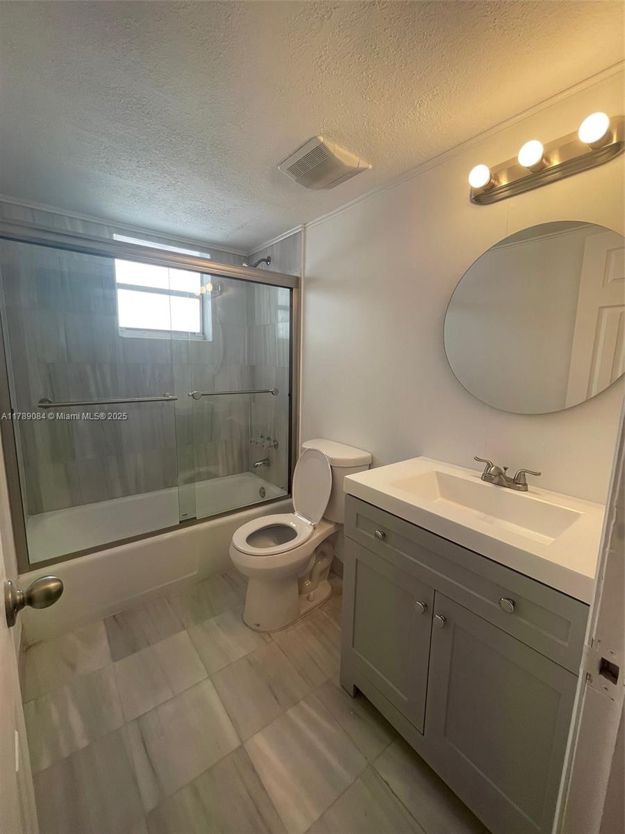 600 Northeast 25th Street, Unit 60 Miami, FL 33137 - Photo 6 of 10 a bathroom with a toilet sink vanity granite and shower