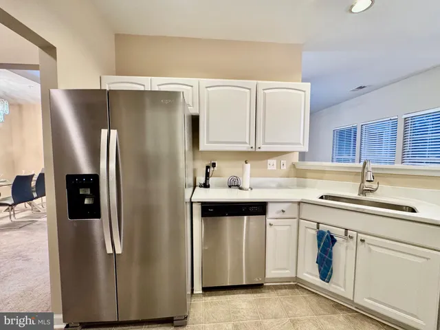 a kitchen with stainless steel appliances granite countertop a sink and cabinets
