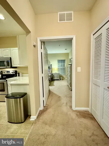 a view of a kitchen with refrigerator and stove