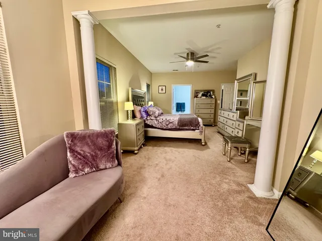 a bedroom with a large bed and a flat tv screen on dresser