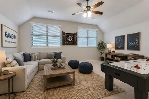 a spacious bedroom with a bed couch and window