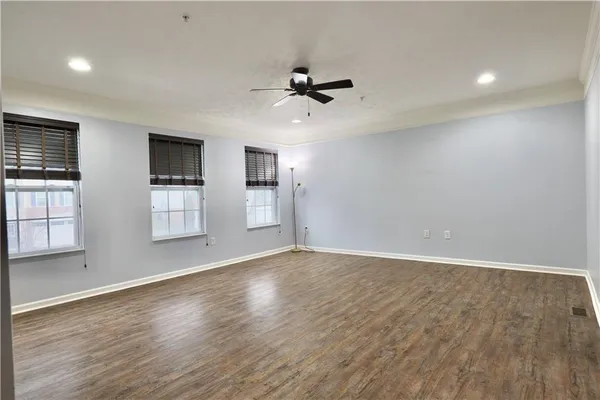 wooden floor in an empty room with a window