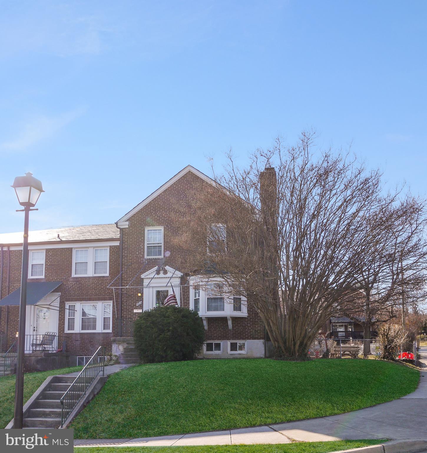 362 Greenlow Road Baltimore, MD 21228 - Photo 2 of 30 a view of a brick building next to a yard