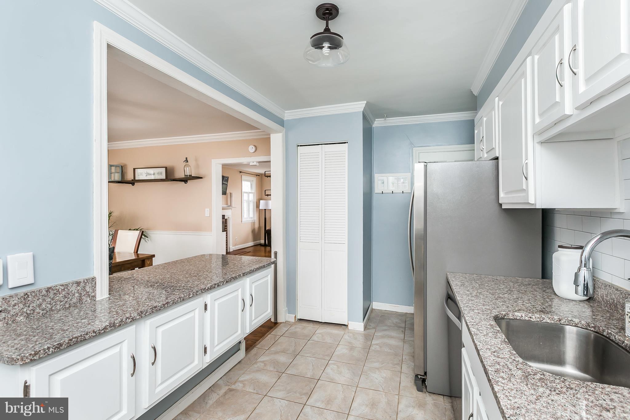 362 Greenlow Road Baltimore, MD 21228 - Photo 12 of 30 a kitchen with granite countertop a sink stove and refrigerator