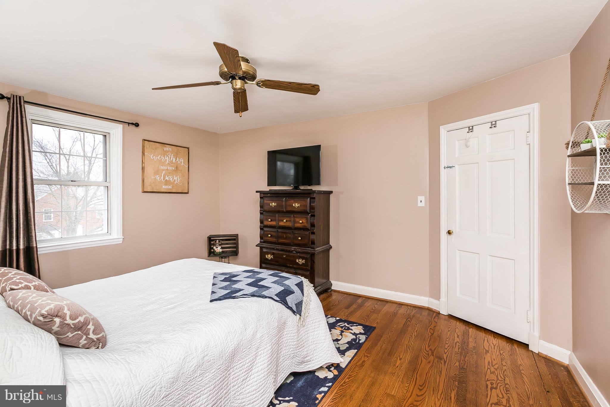 362 Greenlow Road Baltimore, MD 21228 - Photo 14 of 30 a bedroom with a bed and wooden floor