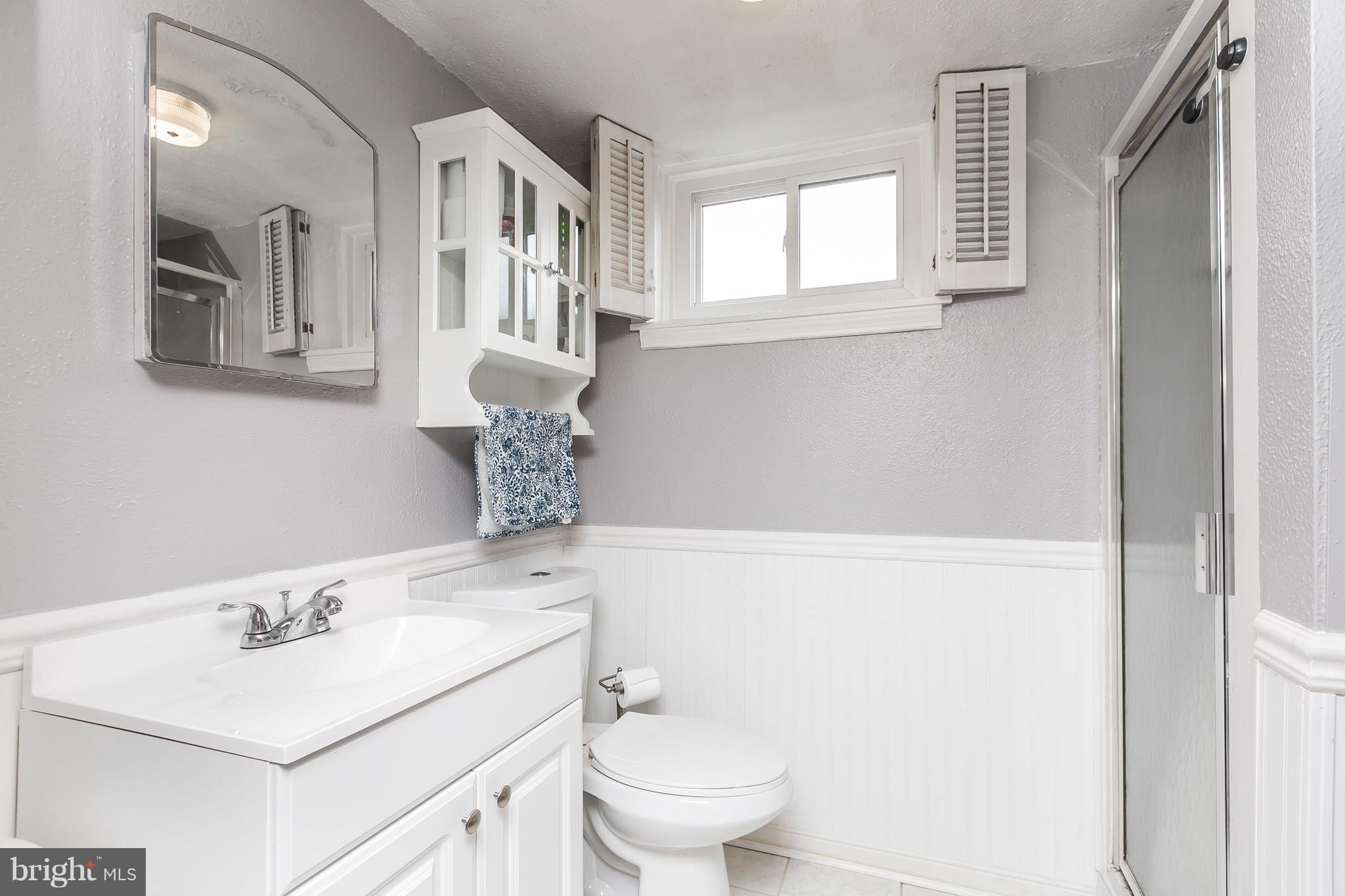 362 Greenlow Road Baltimore, MD 21228 - Photo 21 of 30 a bathroom with a sink toilet and mirror