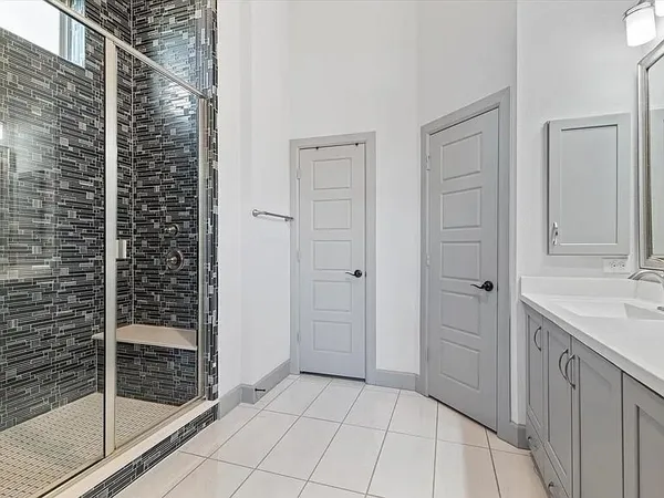 a bathroom with a shower and a sink