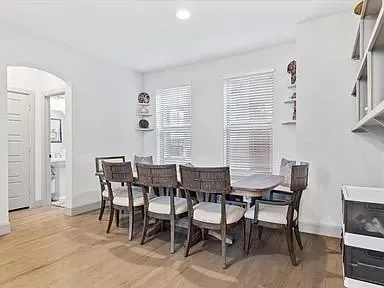 a view of a dining room with furniture and chandelier