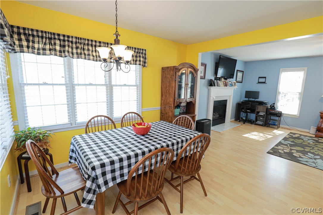 13824 Village Ridge Drive Midlothian, VA 23114 - Photo 12 of 43 a view of a dining room with furniture window and wooden floor