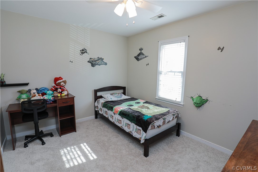 13824 Village Ridge Drive Midlothian, VA 23114 - Photo 31 of 43 a bedroom with a bed and a chandelier