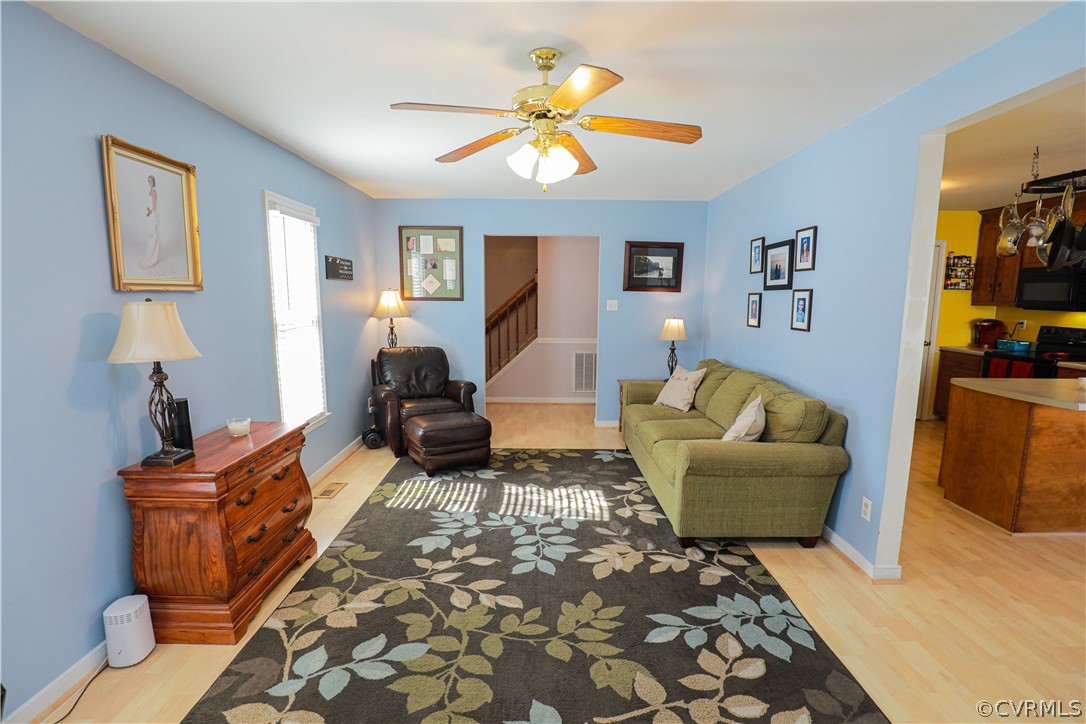 13824 Village Ridge Drive Midlothian, VA 23114 - Photo 7 of 43 a living room with furniture and a chandelier