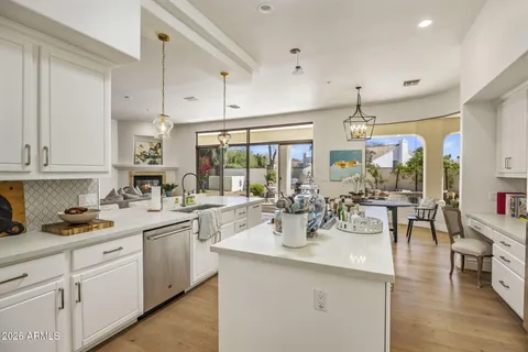 a kitchen with lots of counter top space and chandelier