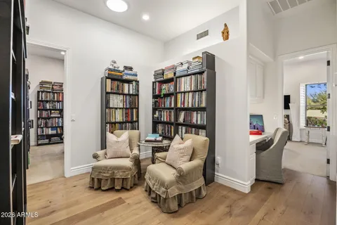 a living room with furniture and a book shelf