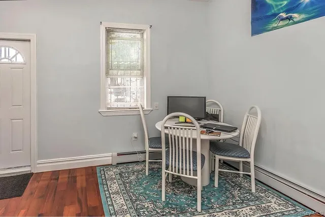 a dining room with a table and chairs