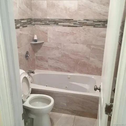 a bathroom with a sink a toilet and bathtub